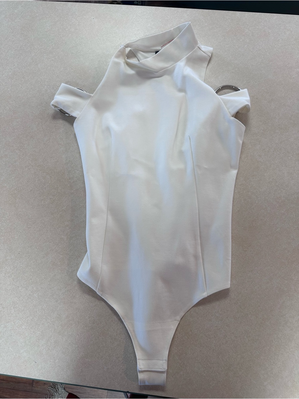 Lavish Alice White cold-shoulder with silver rings on sleeves, body suit.